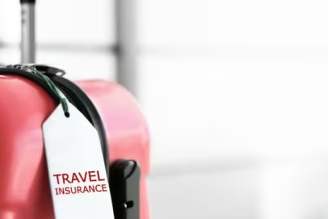 Credit cards with CFAR travel insurance - Suitcase with travel insurance tag - IDFC FIRST Bank