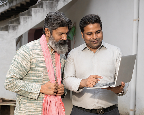 Farmer comparing tractor loan options on a laptop